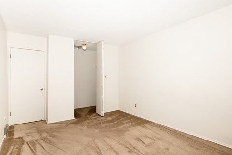 A room with a white door and a white wall.
