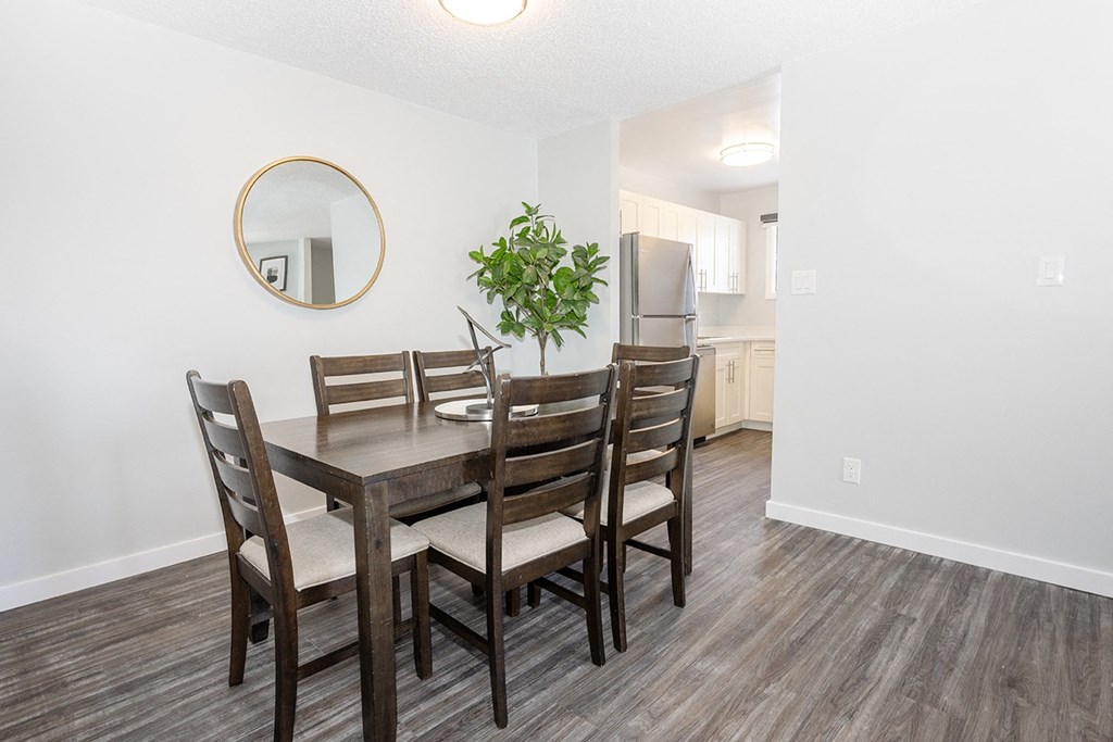 a dining room with a table and chairs and a kitchen