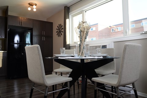 A dining room with a table set for two.