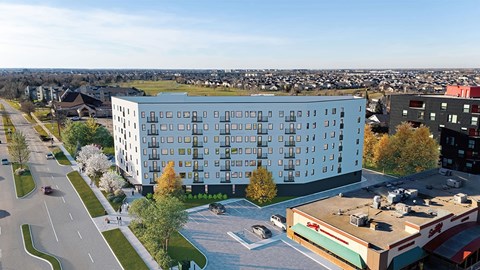 A modern building with a parking lot in front of it.