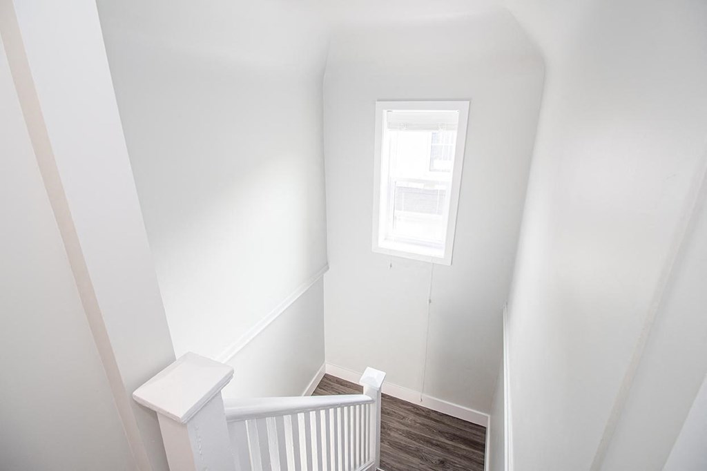 a small white room with a small window