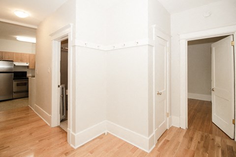 a living room with white walls and a wood floor