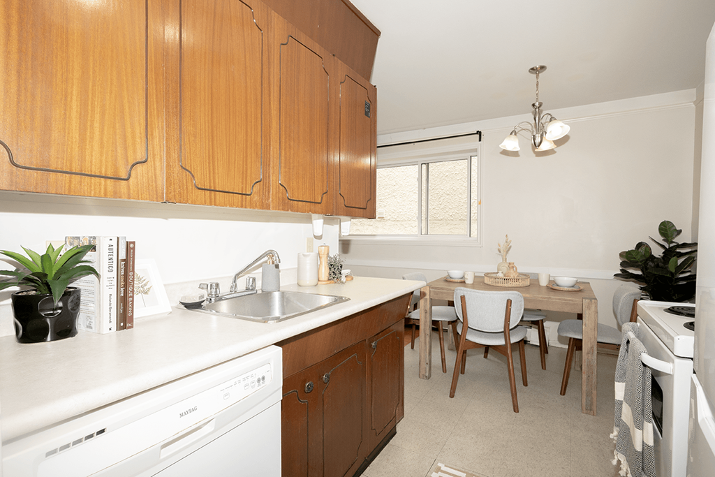 A kitchen with wooden cabinets and white appliances.