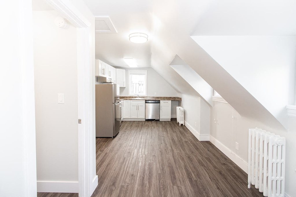 a kitchen and living room in an attic