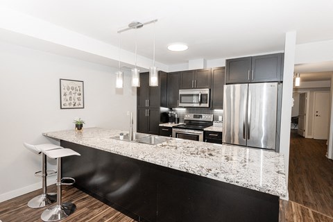 a kitchen with stainless steel appliances and a granite counter top