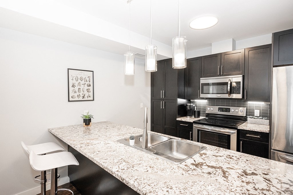 an expansive kitchen with granite countertops and stainless steel appliances