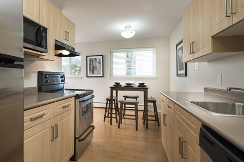 A kitchen with wooden cabinets and stainless steel appliances.