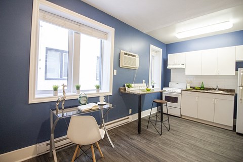 a kitchen and dining room with a table and chairs