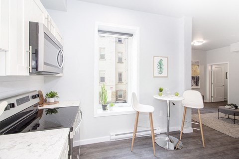 a kitchen with a window and a table and chairs