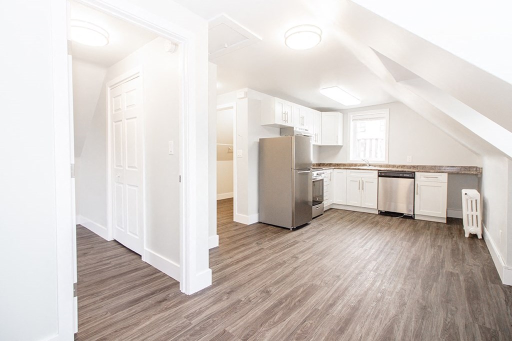 a kitchen and living room in an attic