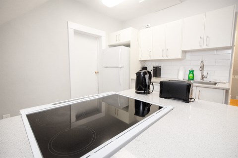 a kitchen with white cabinets and a white counter top