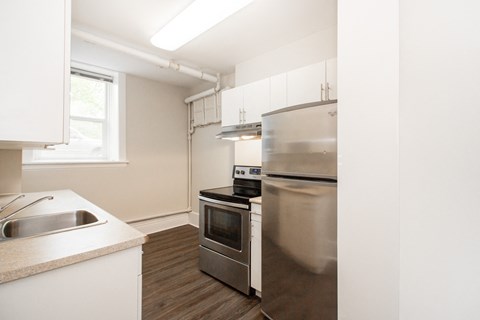 a kitchen with stainless steel appliances and white cabinets