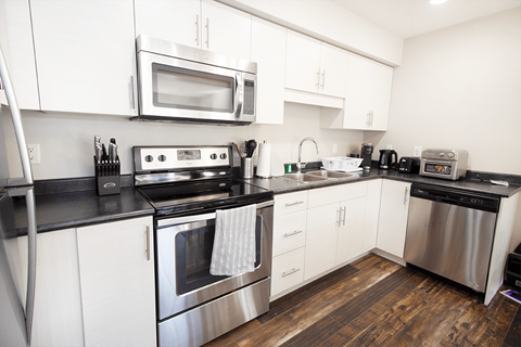 a kitchen with stainless steel appliances and white cabinets