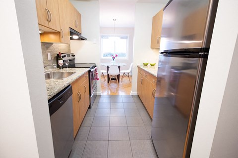 a kitchen with stainless steel appliances and wooden cabinets