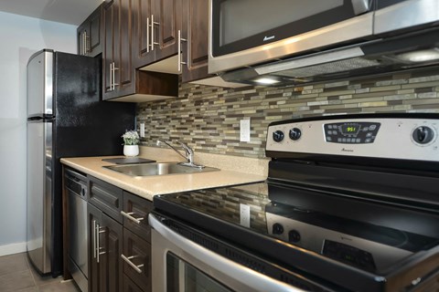 a kitchen with stainless steel appliances and a sink