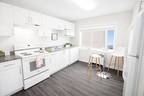 a white kitchen with a table and chairs