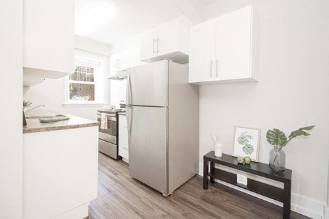 a kitchen with a refrigerator and a table