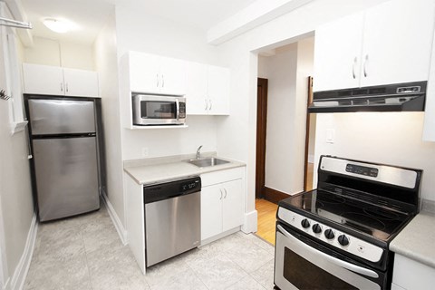 a kitchen with stainless steel appliances and white cabinets