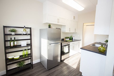 a kitchen with stainless steel appliances and white cabinets