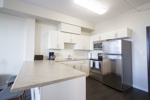 a kitchen with stainless steel appliances and a granite counter top