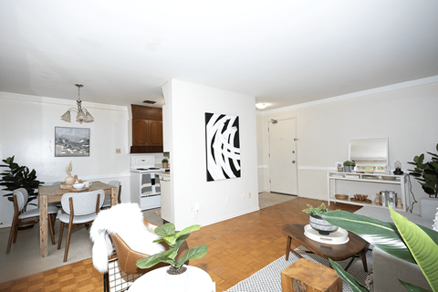 A living room with a dining table and chairs.