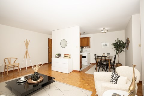 A modern living room with a black coffee table and a white sofa.