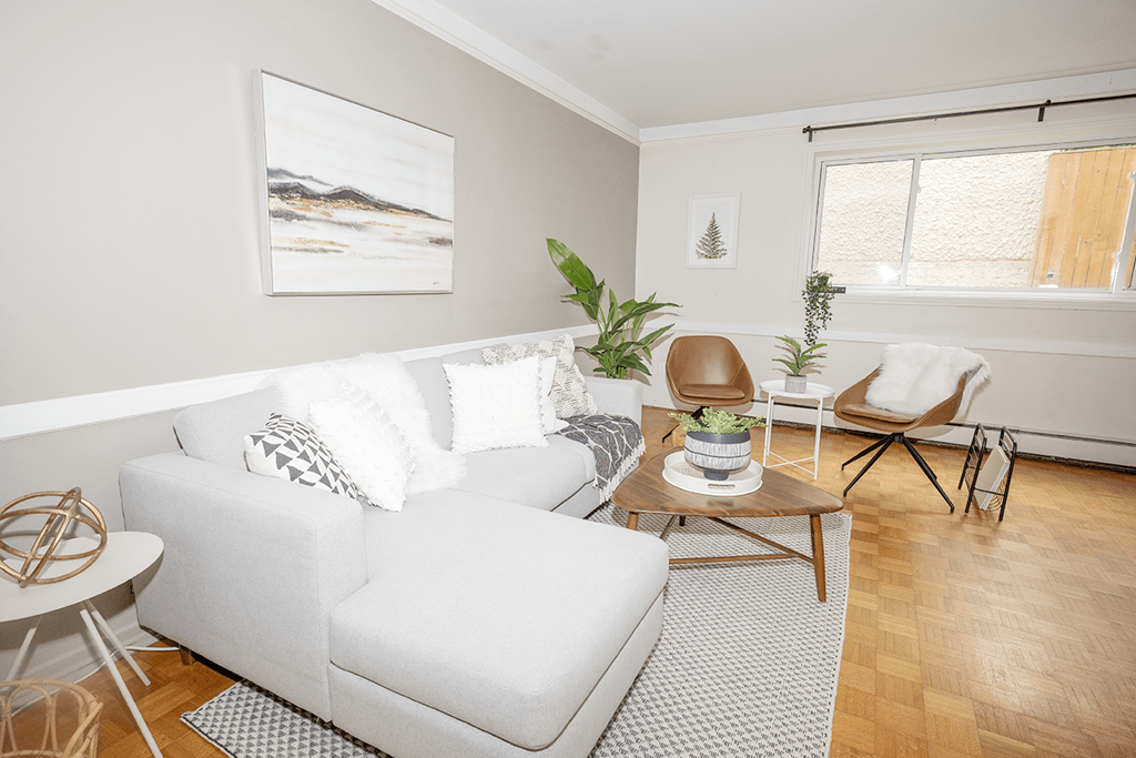 A living room with a white couch and a coffee table.