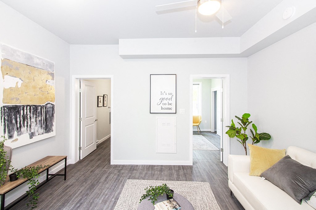 Winnipeg Apartments: a spacious living room with white walls and a white couch