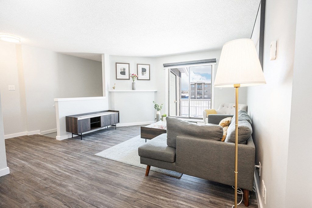 a living room with a couch and a floor lamp
