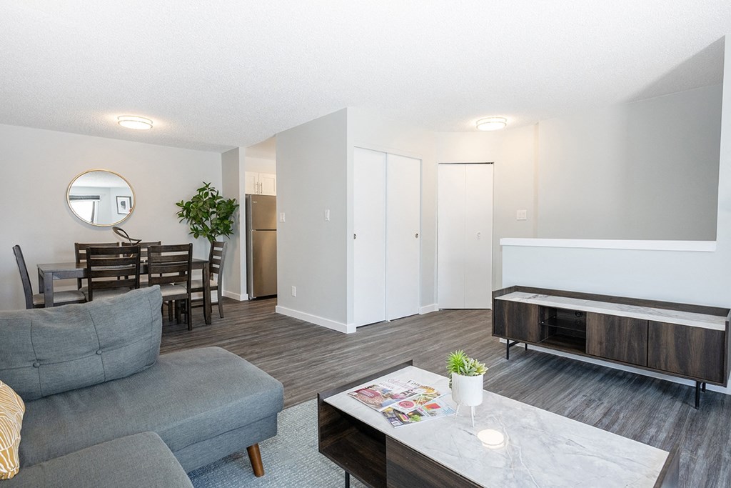 a living room and dining room with a couch and a table