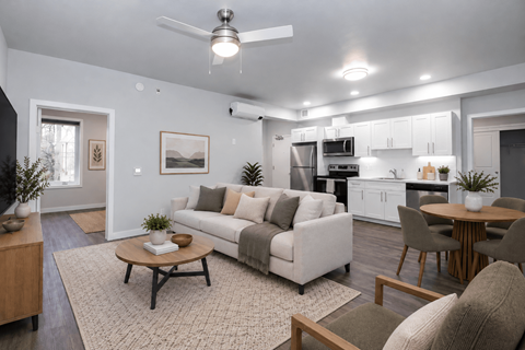 A modern living room with a white couch and a coffee table.