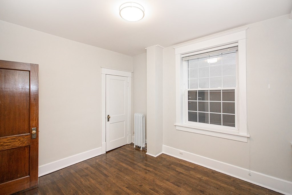 A room with a window and a door.