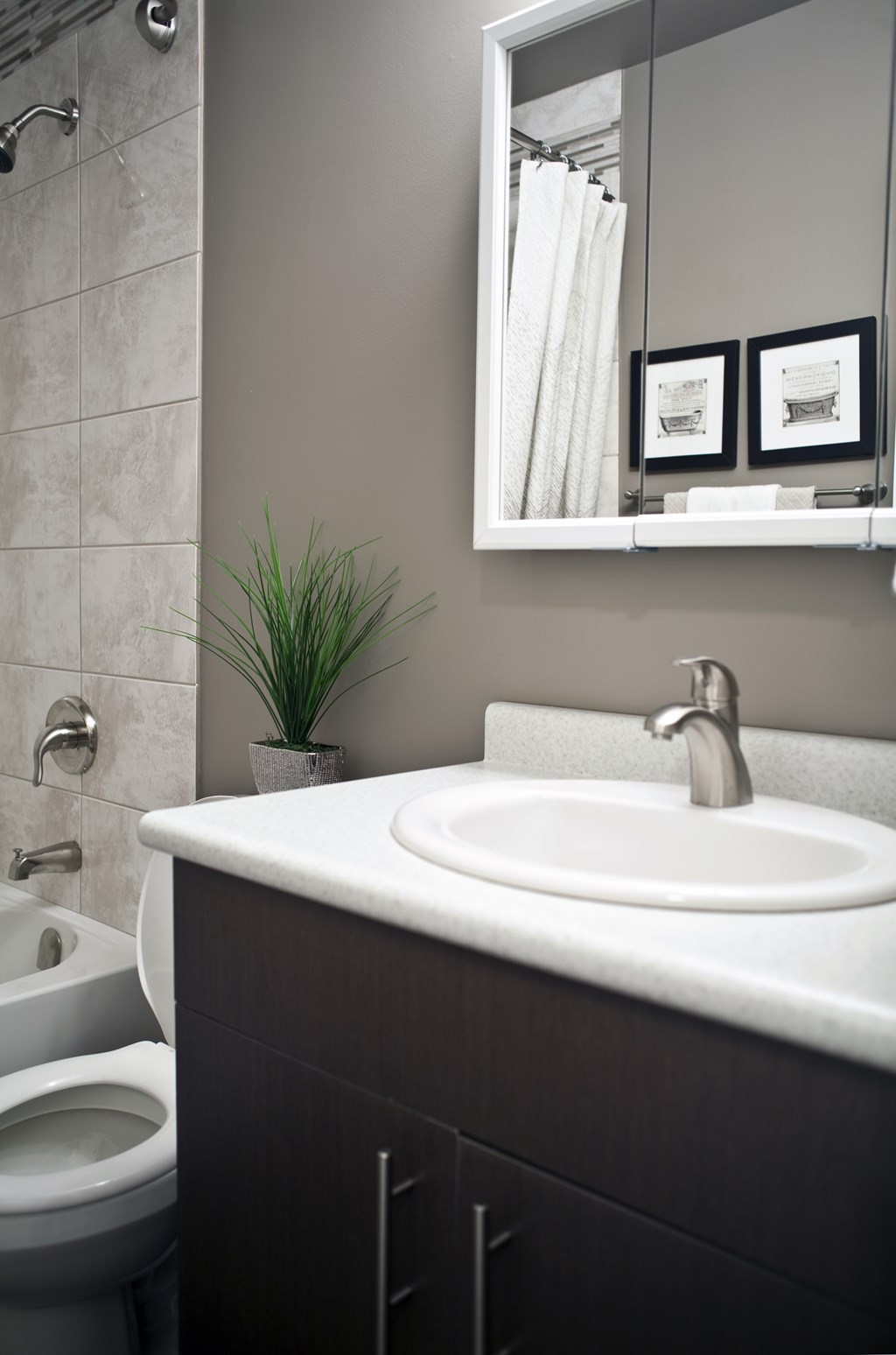 A bathroom with a white sink and a toilet.