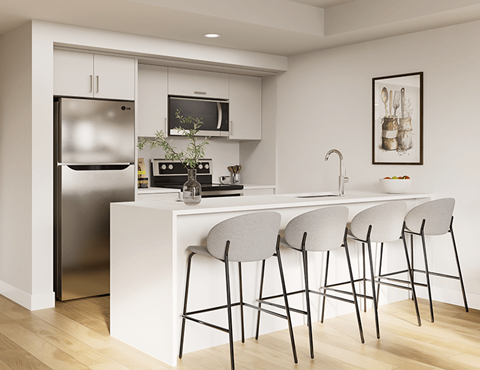 A modern kitchen with white cabinets and a stainless steel refrigerator.