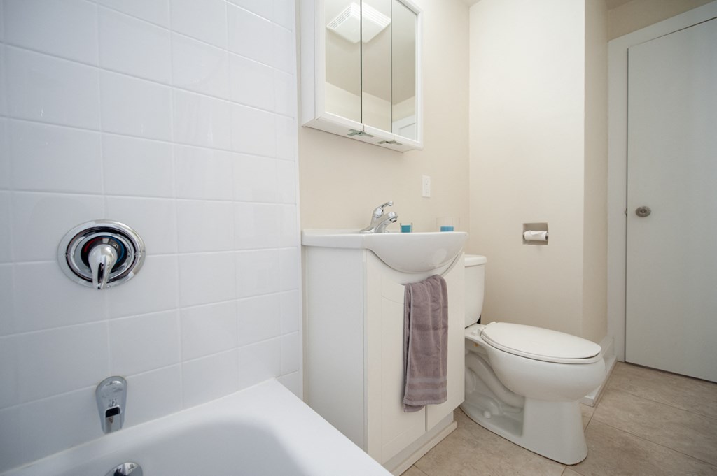 a bathroom with a toilet and a sink and a mirror