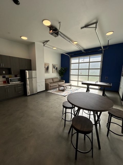 A kitchen with a table and chairs in the middle of the room.
