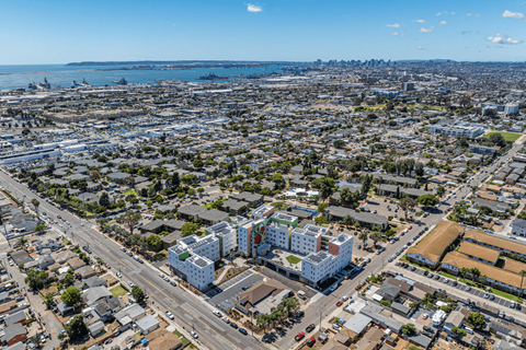 A cityscape with a mix of residential and commercial buildings.