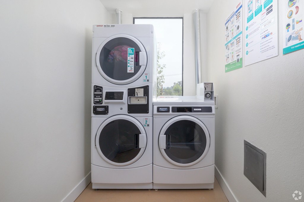 Two front loading washing machines in a laundry room.