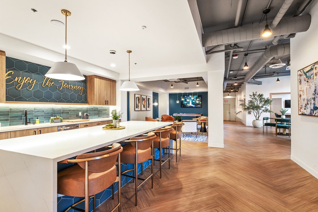 the lobby of a restaurant with a long counter and bar chairs