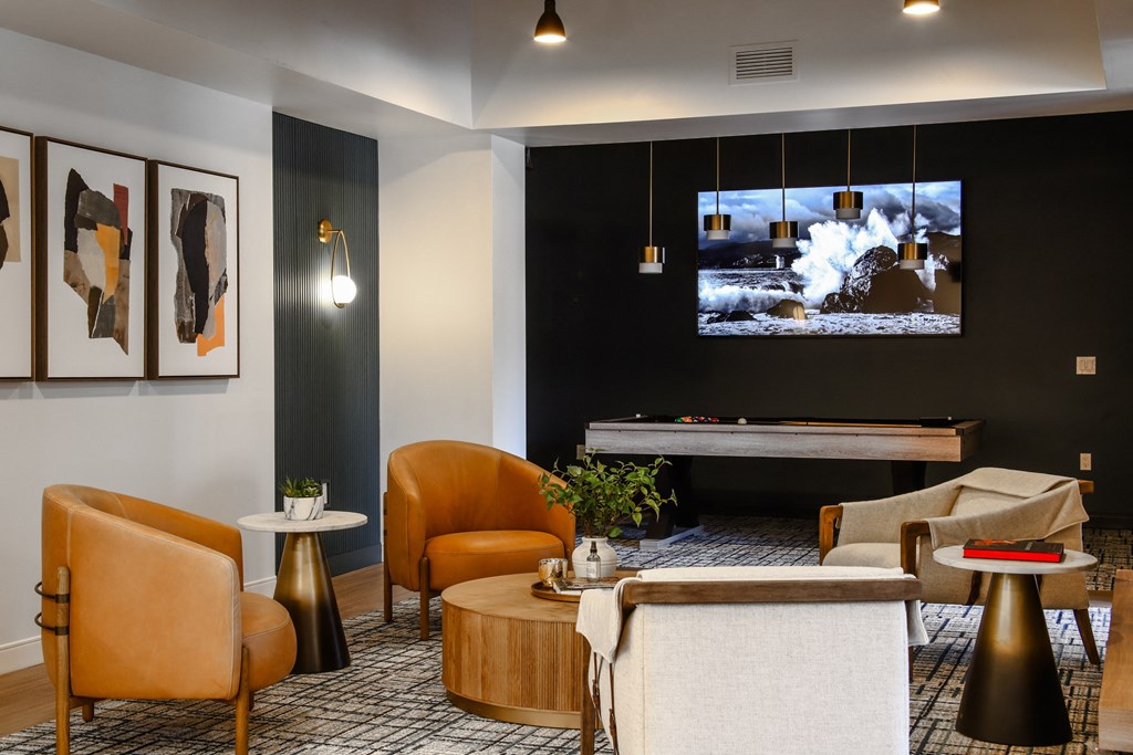 a living room with couches and chairs and a television