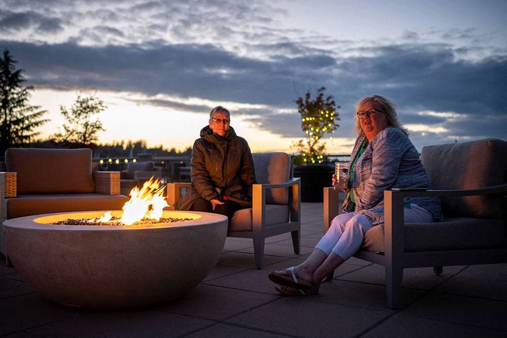 residents at fire pit at Harbor Heights 55+ Community, Washington, 98501