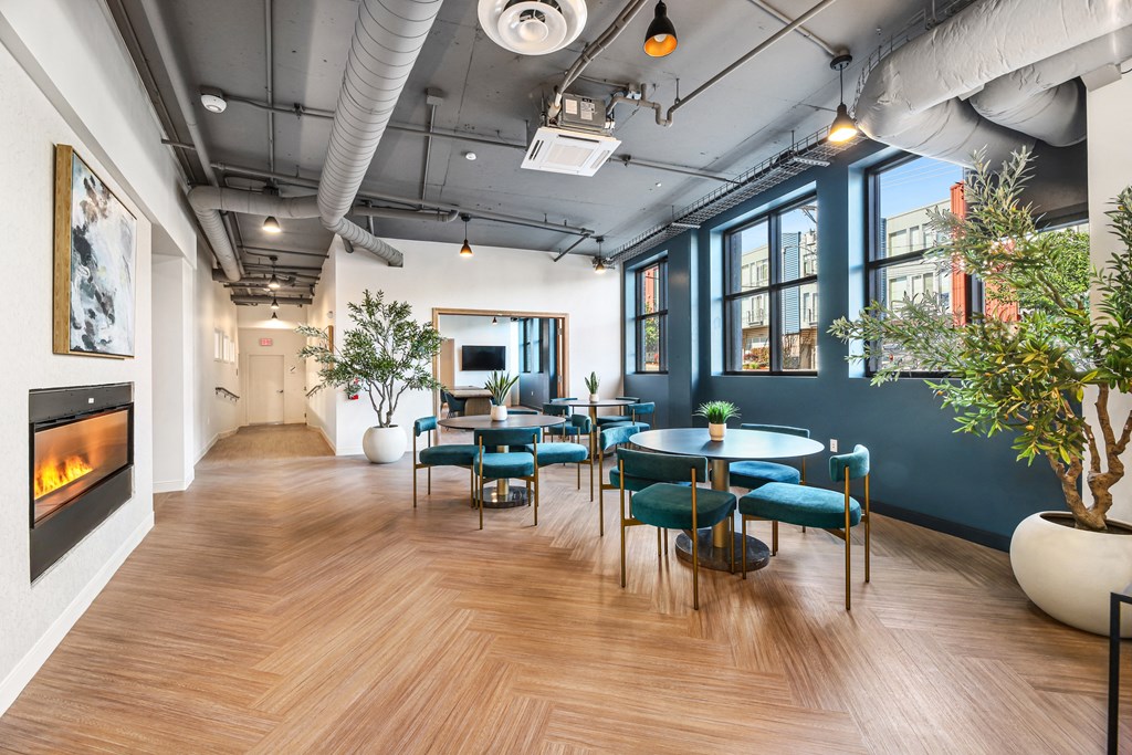 a dining room with blue chairs and tables and a fireplace