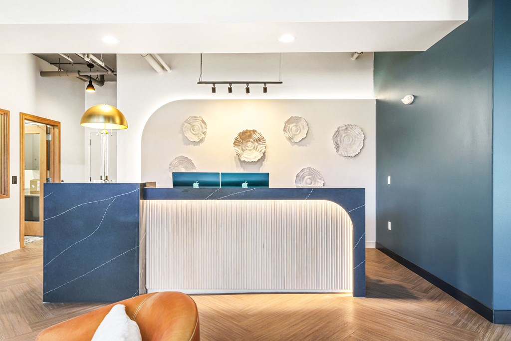 a blue reception desk with a white radiator in a room with blue walls and wood