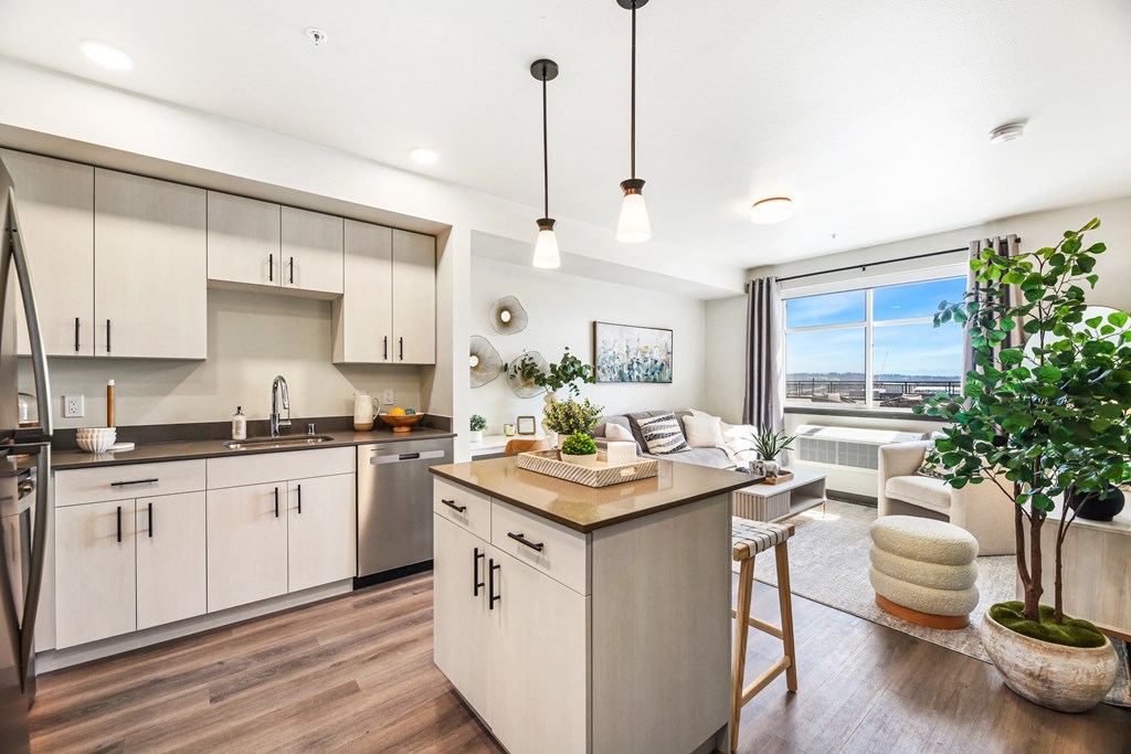 an open kitchen and living room with a large window