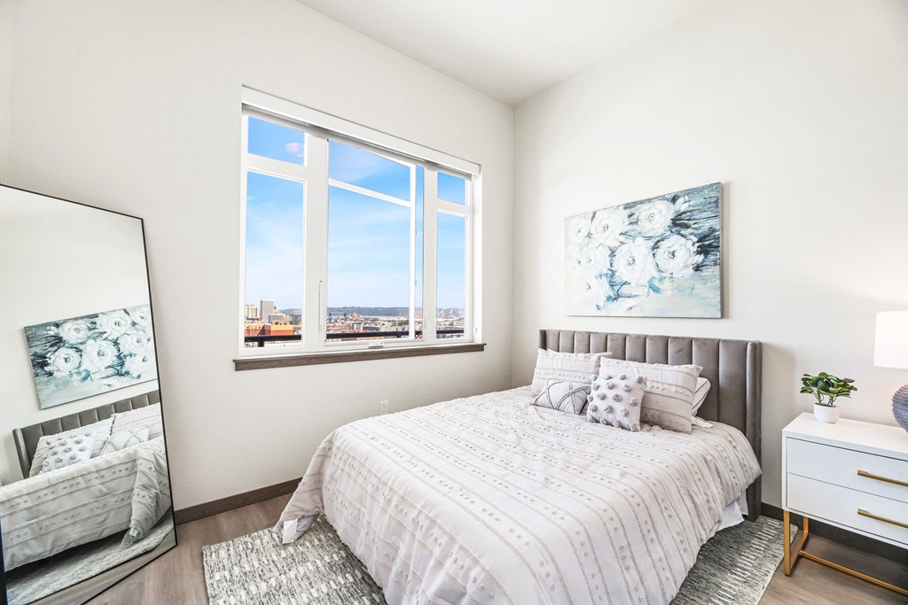 a bedroom with a bed and two windows