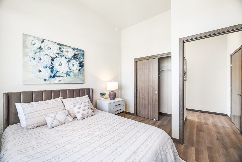 a bedroom with a bed and a painting