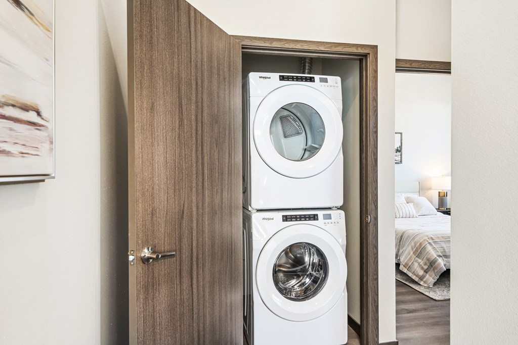 a front loading washer and dryer in a closet in a bedroom