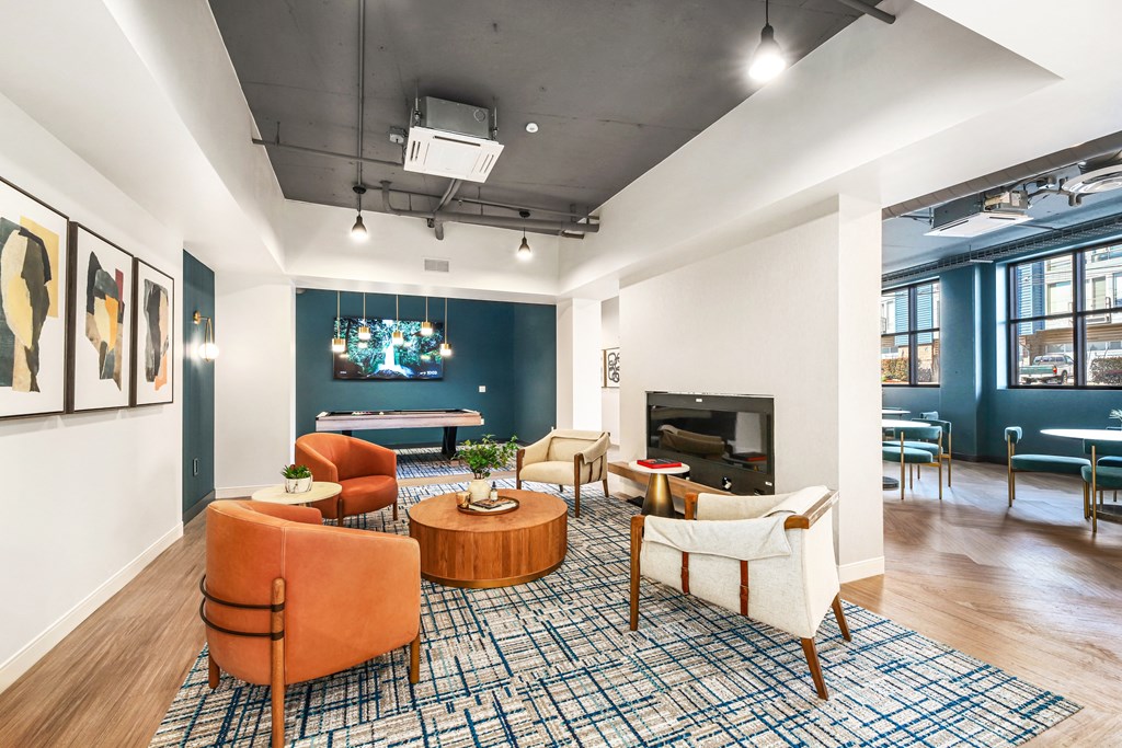 a living room with couches and chairs and a fireplace