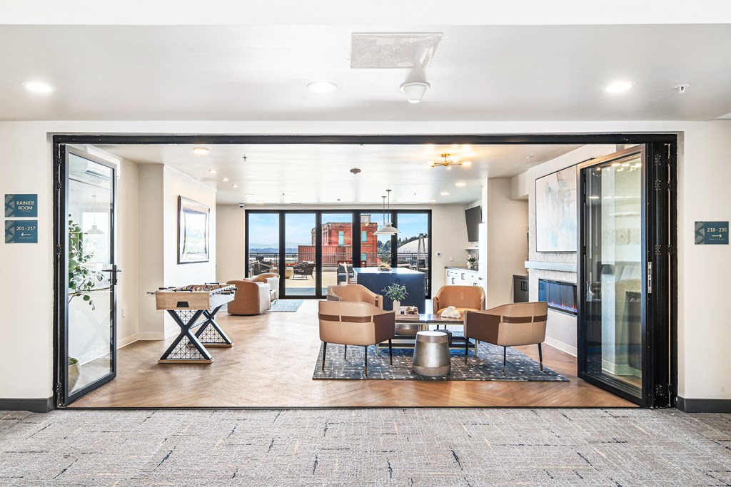 a living room with chairs and a table and sliding glass doors