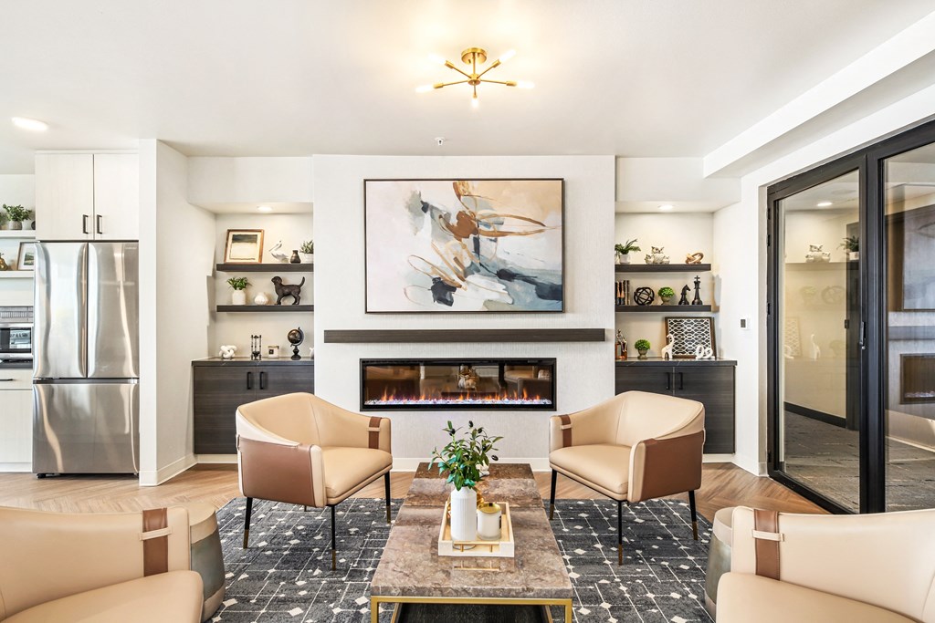a living room with chairs and a fireplace